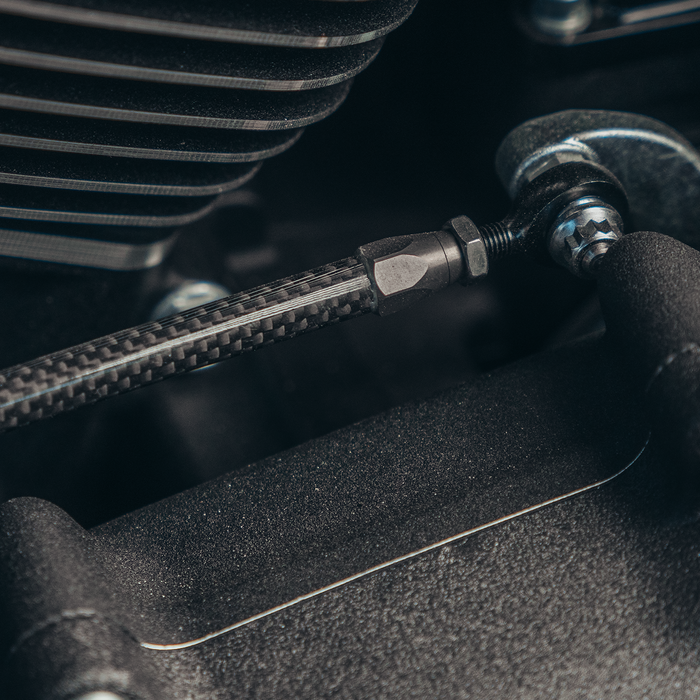 Close-up of Trask carbon fiber shift linkage for Harley-Davidson motorcycles.